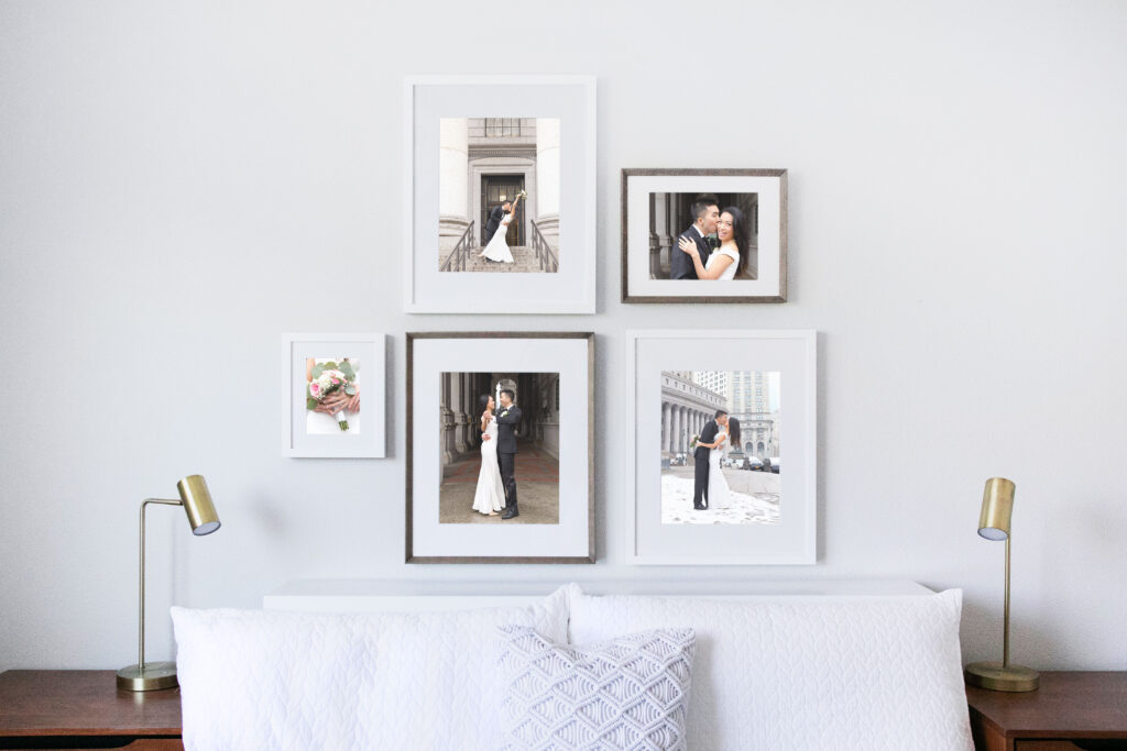 Series of wedding photographs hanging in frames on a wall over a bed in a NYC apartment.