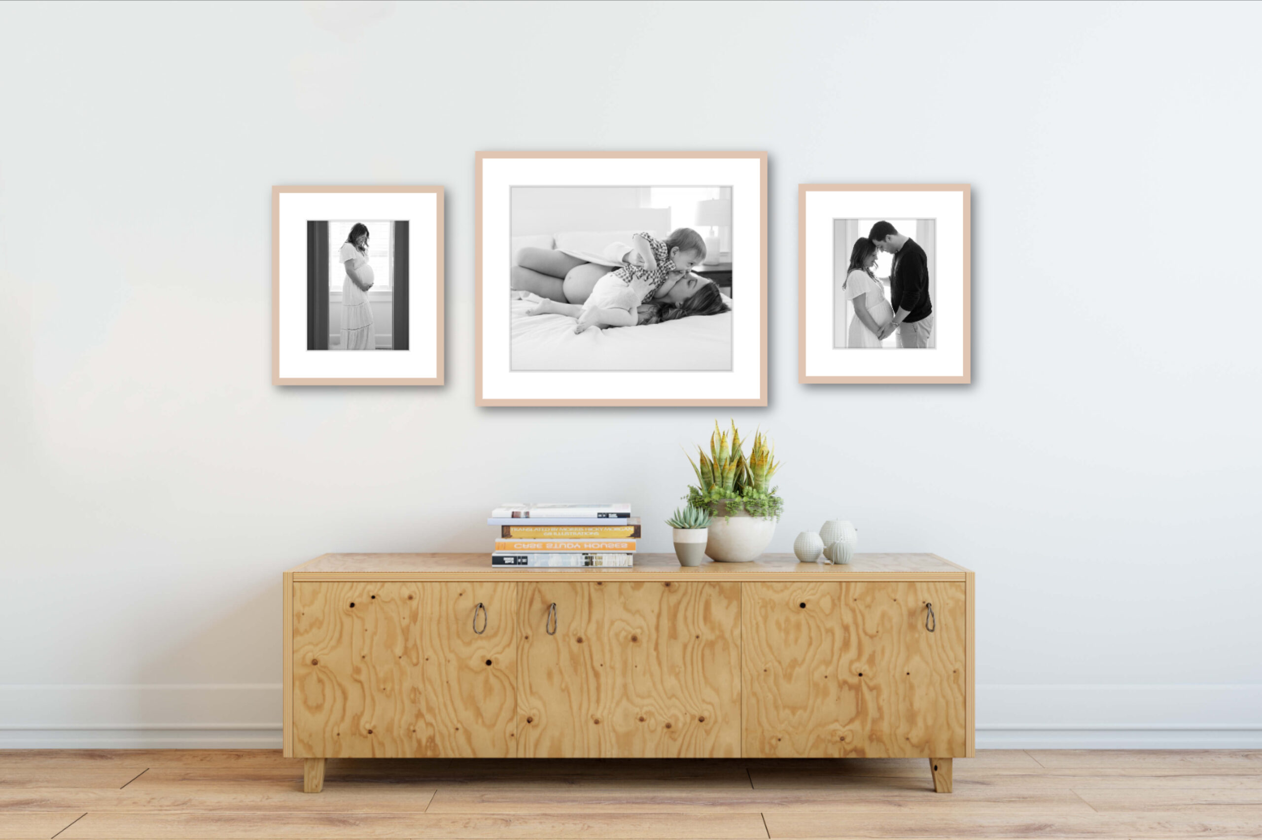 Framed photos of newborn photography hang on a wall in a Greenwich, CT home.
